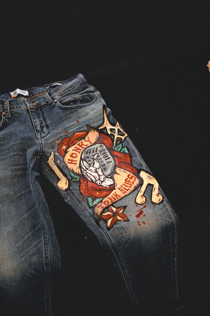Explore this unique pair of jeans featuring a hand-painted artistic design, perfect for fashion enthusiasts.